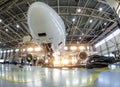 Airplane in the hangar for maintenance, bottom nose view Royalty Free Stock Photo