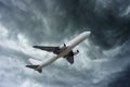 Airplane on impressive gray cloud before rain