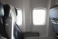 Airplane interior cabine and windows with empty passengers` seats