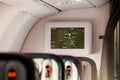 Airplane interior with information display following to Moscow