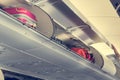 Airplane interior with overhead luggage compartment.