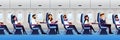 Airplane interior with traveling passengers, seamless horizontal background. People travel by plane. Vector illustration Royalty Free Stock Photo