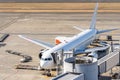 Airplane  at jet bridge in airport Royalty Free Stock Photo