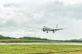 Airplane is landing on the airport before a storm approaching Royalty Free Stock Photo