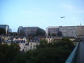 An airplane in landing approach over a city in europe.