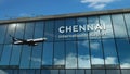 Airplane landing at Chennai India airport mirrored in terminal