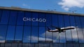 Airplane landing at Chicago Illinois, USA airport mirrored in terminal Royalty Free Stock Photo