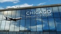 Airplane landing at Chicago Illinois, USA airport mirrored in terminal Royalty Free Stock Photo