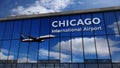 Airplane landing at Chicago, Illinois, USA mirrored in terminal Royalty Free Stock Photo