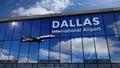 Airplane landing at Dallas DFW mirrored in terminal Royalty Free Stock Photo