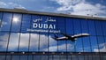 Airplane landing at Dubai mirrored in terminal