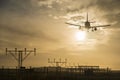 Airplane landing at dusk. Royalty Free Stock Photo