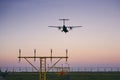 Airplane landing at dusk Royalty Free Stock Photo