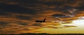 Airplane Landing in Front of Colorado Sunset Royalty Free Stock Photo