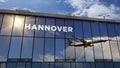 Airplane landing at Hannover Germany airport mirrored in terminal