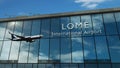 Airplane landing at Lome Togo airport mirrored in terminal