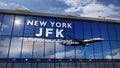 Airplane landing at New York, JFK, Kennedy mirrored in terminal