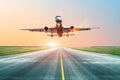 Airplane landing on the runway in the evening at sunset at the airport