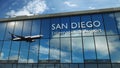 Airplane landing at San Diego California, USA airport mirrored in terminal Royalty Free Stock Photo
