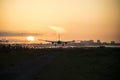 Airplane is landing during sunrise. Royalty Free Stock Photo