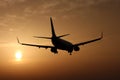 Airplane landing at sunset Royalty Free Stock Photo