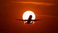 Airplane landing or takeoff in the sunset with red sky in Bucharest international airport , Plain spotting Royalty Free Stock Photo