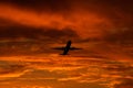 Airplane landing or takeoff in the sunset with red sky in Bucharest international airport , Plain spotting Royalty Free Stock Photo