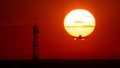 Airplane landing or takeoff in the sunset with red sky in Bucharest international airport , Plain spotting Royalty Free Stock Photo