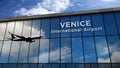 Airplane landing at Venice Italy airport mirrored in terminal