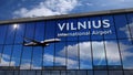 Airplane landing at Vilnius Lithuania mirrored in terminal