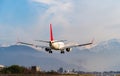 Airplane lands on runway, plane arrives at airport Royalty Free Stock Photo