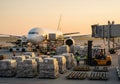 Airplane loading cargo at sunset Royalty Free Stock Photo