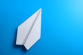 Airplane made of white paper on a blue background Royalty Free Stock Photo