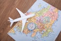 An airplane model and a compass on a paper Japan travel map Royalty Free Stock Photo