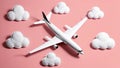 Airplane model displayed on pink with stylized white clouds Royalty Free Stock Photo