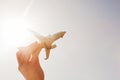 Airplane model in hand on sunny sky. Concepts of travel, transportation Royalty Free Stock Photo