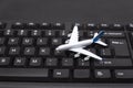 Airplane model on the keyboard. Online booking of air tickets. Buying tickets