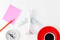 Airplane model with pencil and paper note,compass and red coffee Royalty Free Stock Photo
