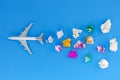 Airplane model with various paper ball on blue background with copy space.Preparation for Traveling and tour concept Royalty Free Stock Photo