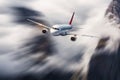 Airplane in motion. Aircraft with motion blur effect is flying in clouds against mountains. Passenger airplane Royalty Free Stock Photo