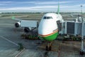 Airplane near the terminal under blue sky