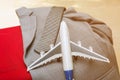 airplane with necktie and suit on red suitcase, business travel