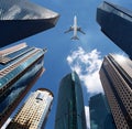 Airplane over office buildings. Royalty Free Stock Photo