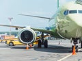 Airplane parked at the airport before departure, loading baggage Royalty Free Stock Photo