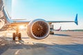 Airplane is parked at the airport before departure, the view on the wing of the chassis rack gear engine, on the sunny day. Royalty Free Stock Photo