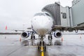 Airplane is parked at the airport with a gangway waiting for boarding of passengers. Royalty Free Stock Photo