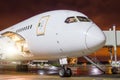 Airplane parked at the airport at night, view nose cockpit. Royalty Free Stock Photo