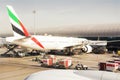 Airplane parked at Dubai`s international airport dock, loading goods and preparing before the flight