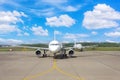 Airplane parked in good weather at the airport, straight view