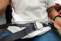 Passenger with fastened seat belt seated on aircraft seat for safety